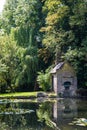 Old pump house on a small pond in a park in London Royalty Free Stock Photo