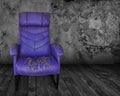 Old purple chair in a dark room