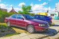 Old purple red Audi 80 private car sedan parked right side front view