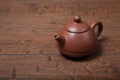 Old purple yixing clay Chinese teapot yuan zhu hu type for tea ceremony on wooden table