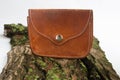 Old purse made of genuine leather on a background of old wood. Purse in country style Royalty Free Stock Photo