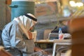 Old qatari man asleep at a table of a cafe in Souq Wakif, Doha