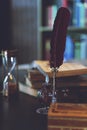 Old quill pen, books and vintage inkwell on wooden desk in the old office against the background Royalty Free Stock Photo