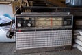 Old radio receiver in the garage. Dusty radio on a shelf