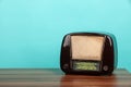 Old radio on table in front of green background. Vintage style photo Royalty Free Stock Photo