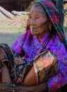 Old Rai woman with wrinkled face in traditional dress and ornaments