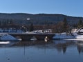 Old railroad stone bridge in rural village Schluchsee, Germany in Black Forest crossing a frozen lake in winter. Royalty Free Stock Photo