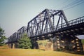 Old railroad tracks on Black Bridge or Lampang Railway Bridge. Railway bridge on river at Lampang thailand Royalty Free Stock Photo