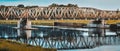 Old railway bridge over the Odra River. The metal openwork structure allows crossing to the other shore Royalty Free Stock Photo