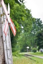 Old railway crossing sign on wooden post Royalty Free Stock Photo