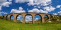 Old railway stone viaduct in the spring in sunny day