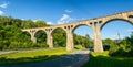 Old railway viaduct in the mountains above the road, Lewin Klodzki Royalty Free Stock Photo