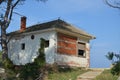 An old ramshackle house with a damaged facade and no windows Royalty Free Stock Photo