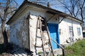 Old ramshackle house on hill among spring trees Royalty Free Stock Photo