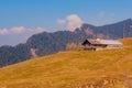 Old ranch on a mountain with alpine mountain in the background on a summer day Royalty Free Stock Photo