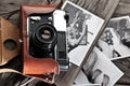 Old rangefinder camera and black-and-white photos. Royalty Free Stock Photo