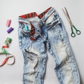 Old raped jeans with and sewing tools top view Royalty Free Stock Photo