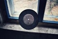 An old record is leaning against the window in an abandoned house in the Chernobyl exclusion zone in modern day Ukraine.