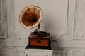 Old record player against ancient wooden wall. Antique gramophone with retro plate produces pleasant sounds or music. Stereo Royalty Free Stock Photo