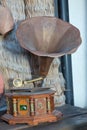 Old record player against ancient wooden wall. Antique gramophone with retro plate produces . Vinyl record set Stereo