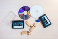 Old recorder cartridge, USB stick, and compact disks together Royalty Free Stock Photo