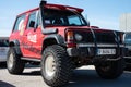 Old red all-terrain Mitsubishi Montero parked on the street