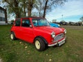 Old red 1963 Austin Mini Cooper S Mark I sedan on the lawn. Classic car show. Royalty Free Stock Photo