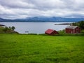 An old red barn on the coast of the Norwegian fjord