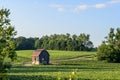 Old red barn on green farmers field Royalty Free Stock Photo