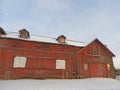 Historic old red barn illuminated by setting winter sun Royalty Free Stock Photo