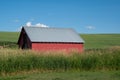 Old red barn in the middle of a field in the Palouse region of Eastern Washington State Royalty Free Stock Photo