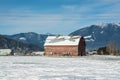 Old red barn on mountaing view background Royalty Free Stock Photo