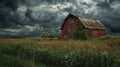 Old red barn in a stormy countryside landscape, dramatic rural scene Royalty Free Stock Photo