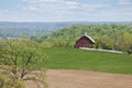 Old red barn, trees and fields in the Iowa countryside Royalty Free Stock Photo