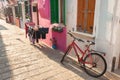 Old red bicycle parked long an external wall in Burano island, V Royalty Free Stock Photo