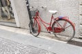Old red bicycle on the street in Verona, Veneto, Italy