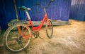 Old red bike parked near the blue wall Royalty Free Stock Photo