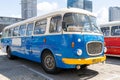 The old blue Skoda bus rides through the streets of the Polish capital. Tourist bus vintage model. The street of the old