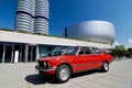 Old red BMW series 3 coupe standing next to BMW Museum in Munich, Germany Royalty Free Stock Photo