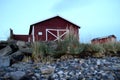 Old red boat house next to sea shore Royalty Free Stock Photo