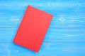 Old red book on wooden plank background. Blank empty cover for d Royalty Free Stock Photo