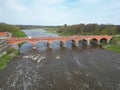 The old red brick bridge across the Venta river. Kuldiga, Latvia Royalty Free Stock Photo