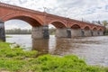 The old red brick bridge across the Venta river. Kuldiga, Latvia Royalty Free Stock Photo