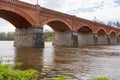 The old red brick bridge across the Venta river. Kuldiga, Latvia Royalty Free Stock Photo