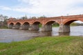The old red brick bridge across the Venta river. Kuldiga, Latvia Royalty Free Stock Photo