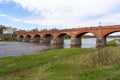 The old red brick bridge across the Venta river. Kuldiga, Latvia Royalty Free Stock Photo