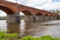 The old red brick bridge across the Venta river. Kuldiga, Latvia Royalty Free Stock Photo