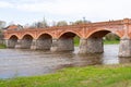The old red brick bridge across the Venta river. Kuldiga, Latvia Royalty Free Stock Photo