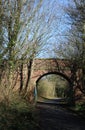 Old red brick bridge over disused railway line Royalty Free Stock Photo