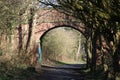 Old red brick bridge over disused railway line Royalty Free Stock Photo